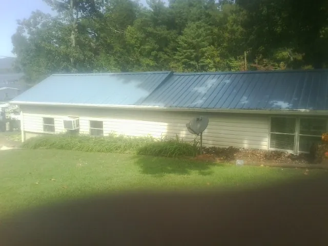Blue metal roof running the length of a single story home in Garfield